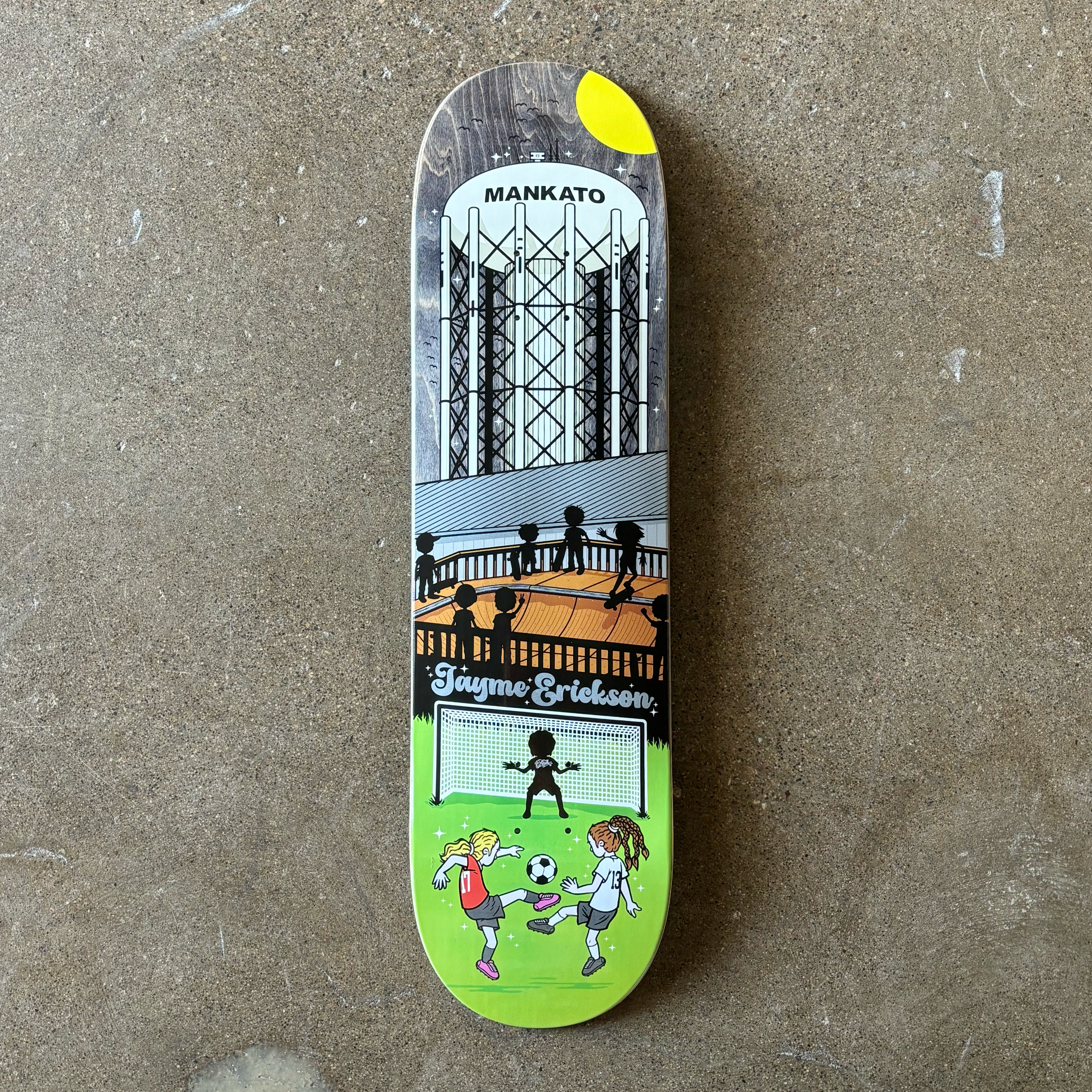 FULL IMAGE OF DECK
CARTOON DRAWING OF KIDS PLAYING SOCCER WITH SHADOWS OF SKATEBOARDERS ON A MINI-RAMP IN BACKGROUND.
MANKATO WATER TOWER FINISHES THE IMAGE ON ASSORTED VENEERS.