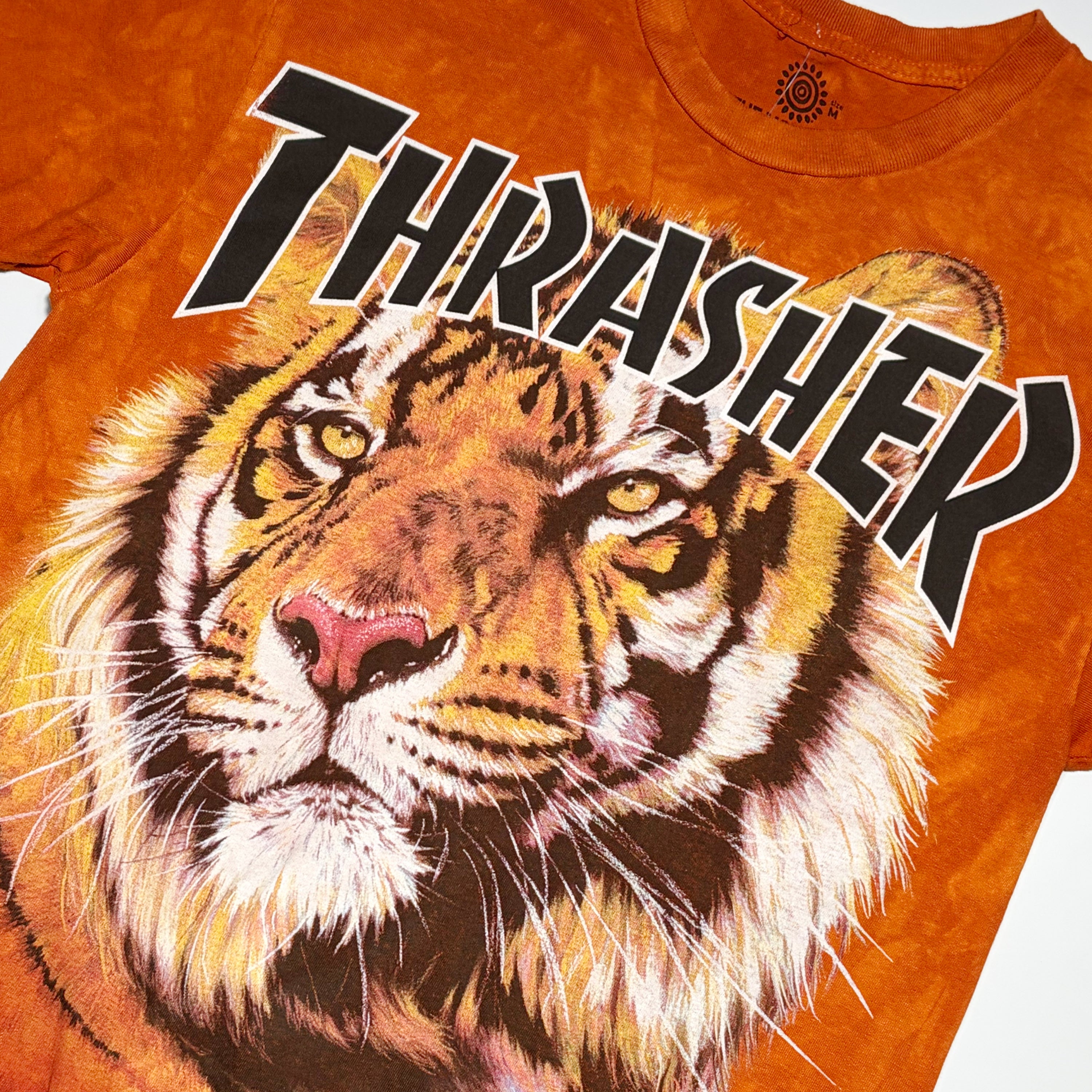 Close detail of Thrasher tiger art printed on chest.