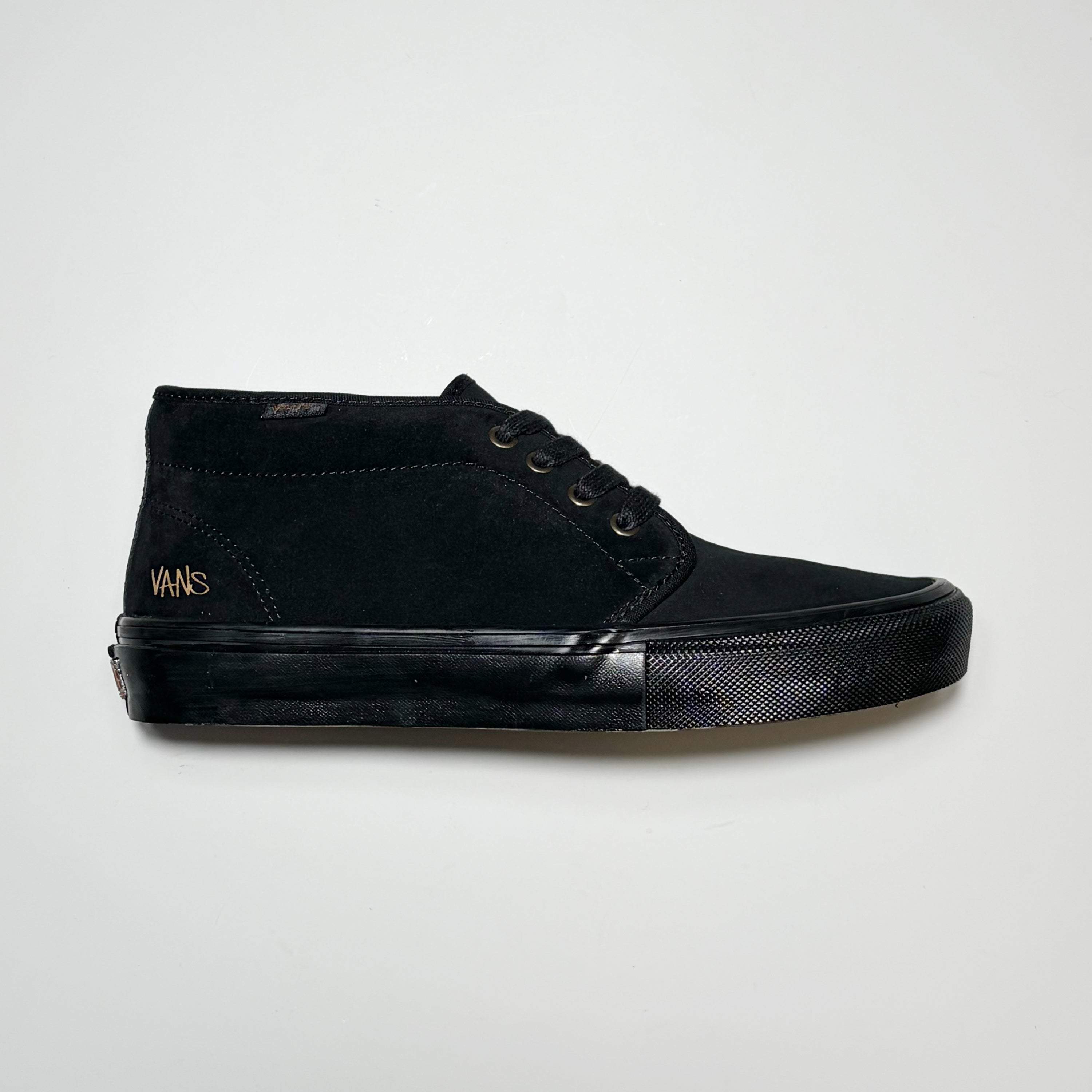 Right side image, Vans Skate Chukka sneaker by Atiba Jefferson. All black suede upper and matching tonal outsole on grey background.