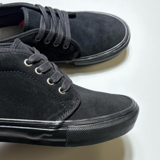 A pair of black suede low-top sneakers with black laces and black rubber soles, photographed on a clean white background. Vans Skate Chukka by Atiba Jefferson