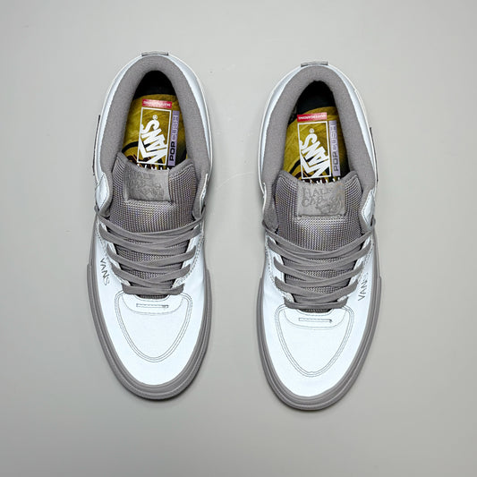 A pair of Vans Skate Half Cab sneakers in metallic silver and gray, shown from a top-down view on a neutral gray background.