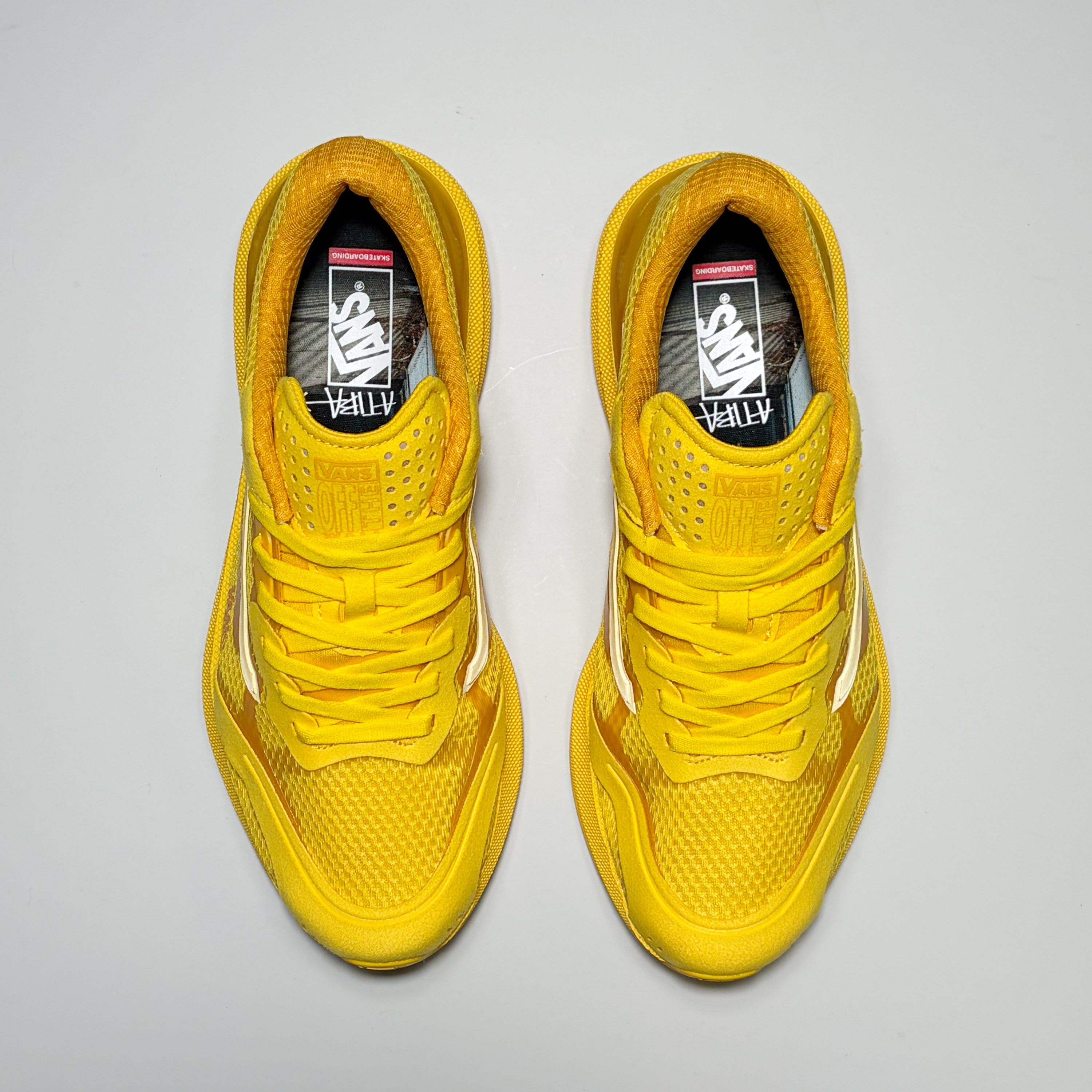 A pair of yellow Vans AVE Rapid LX Atiba Jefferson sneakers shown from a top-down view on a light gray background.