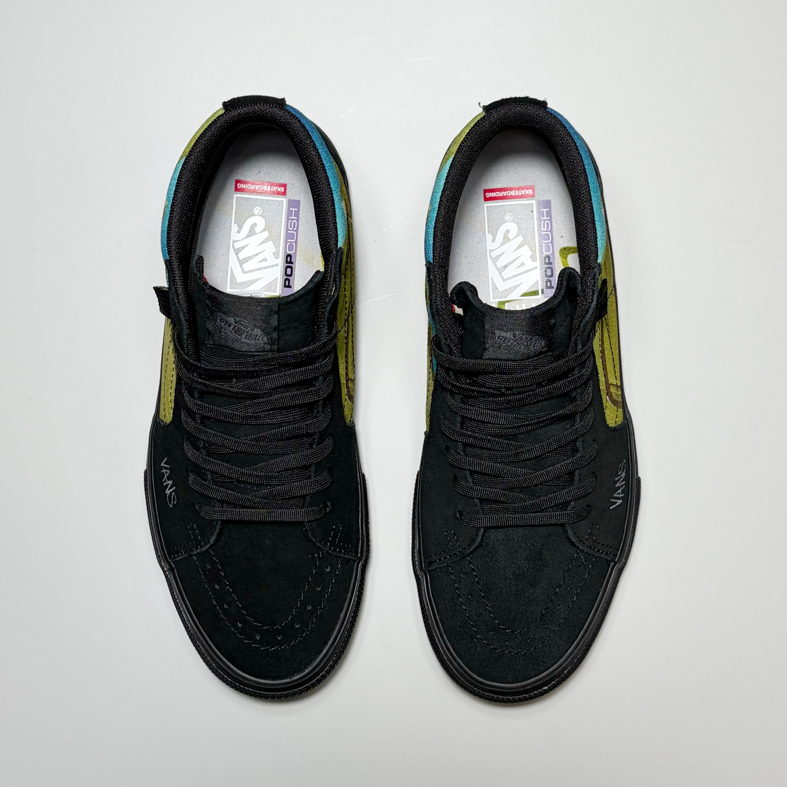 A pair of black Vans Skate Sk8-Hi by Atiba Jefferson. Shown from a top-down view on a light gray background.