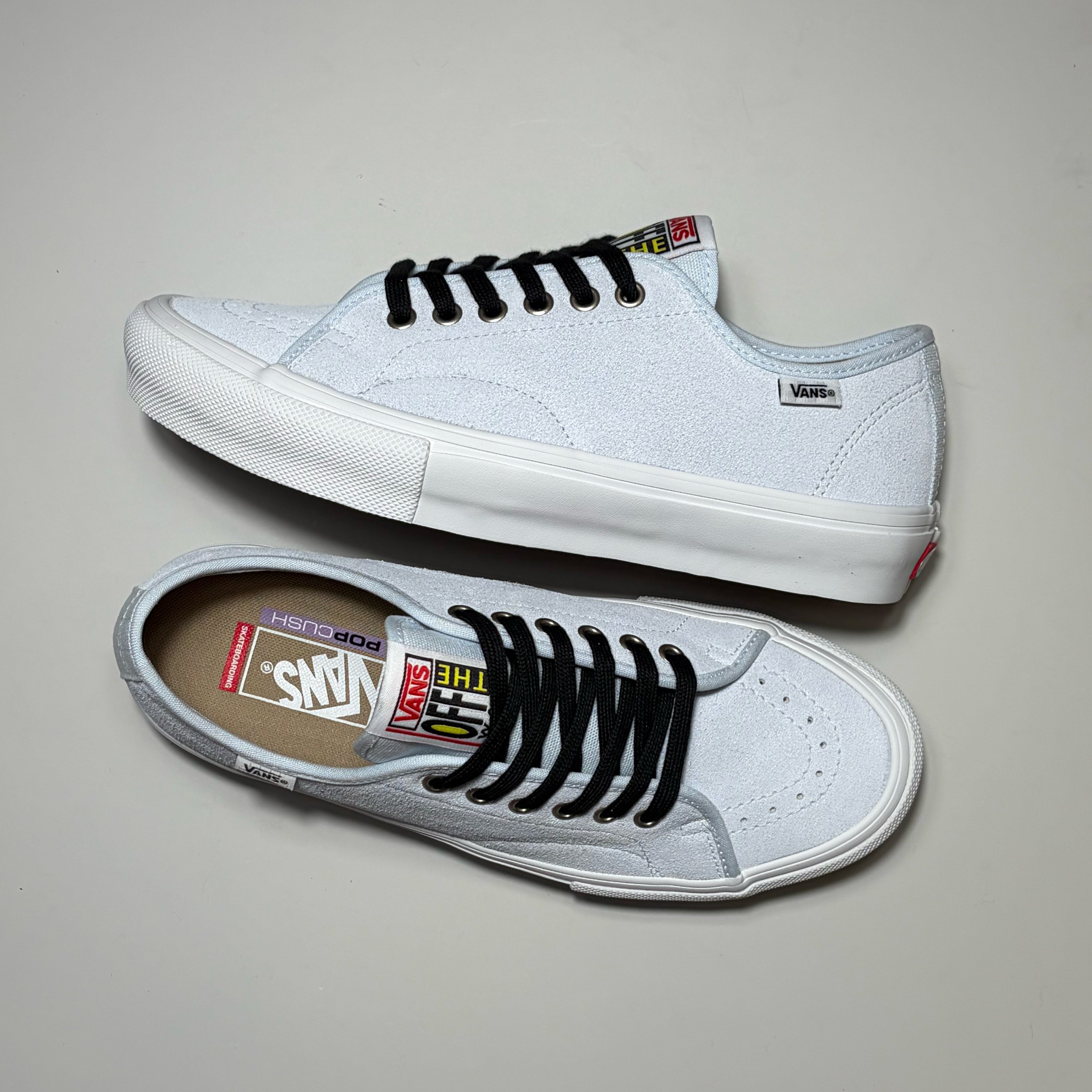 A pair of white Vans Skate AVE Classic sneakers with black laces, shown from both side and top-down angles on a neutral gray background.