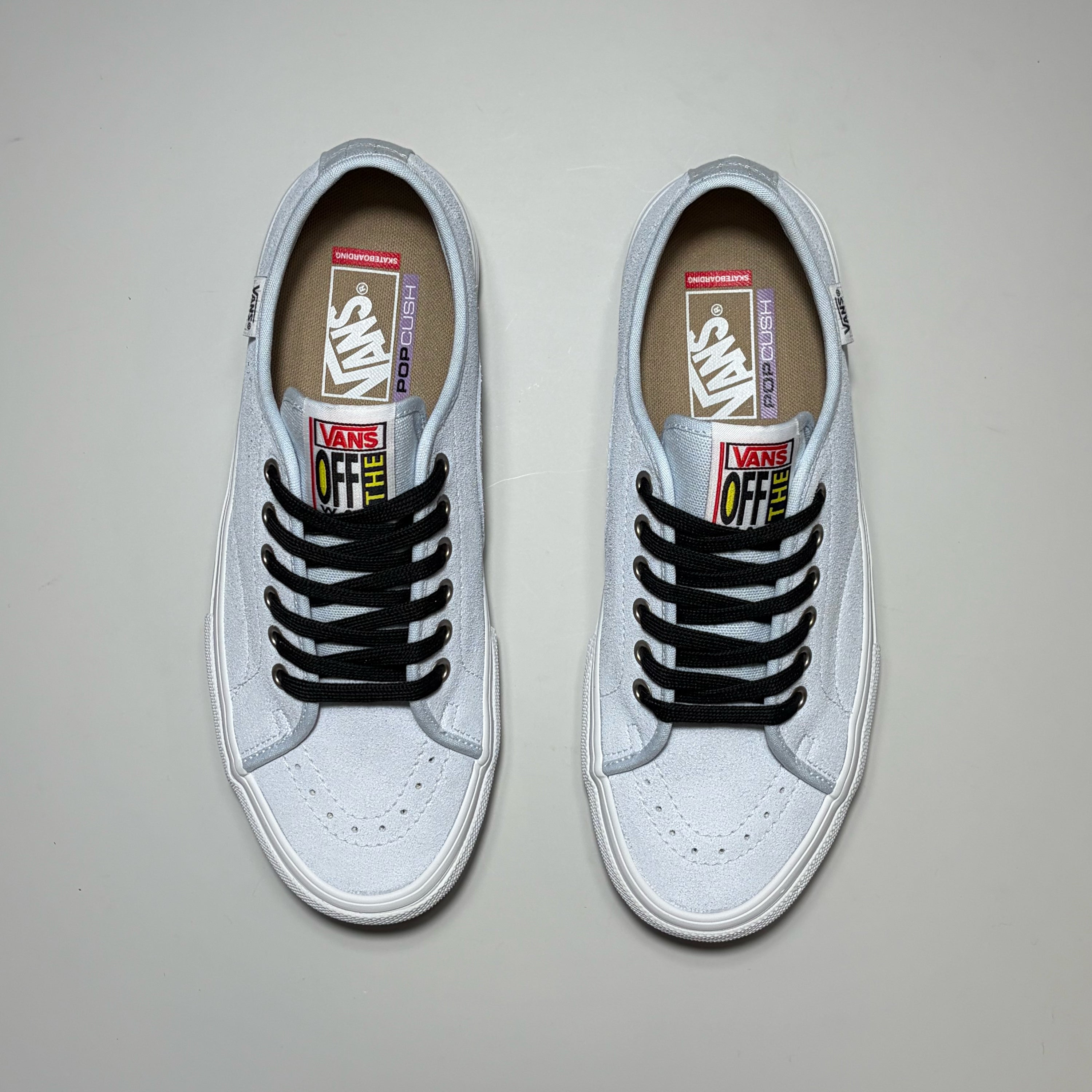 A pair of Vans Skate AVE Classic low-top sneakers in light blue suede with black laces, shown from a top-down view on a neutral gray background.