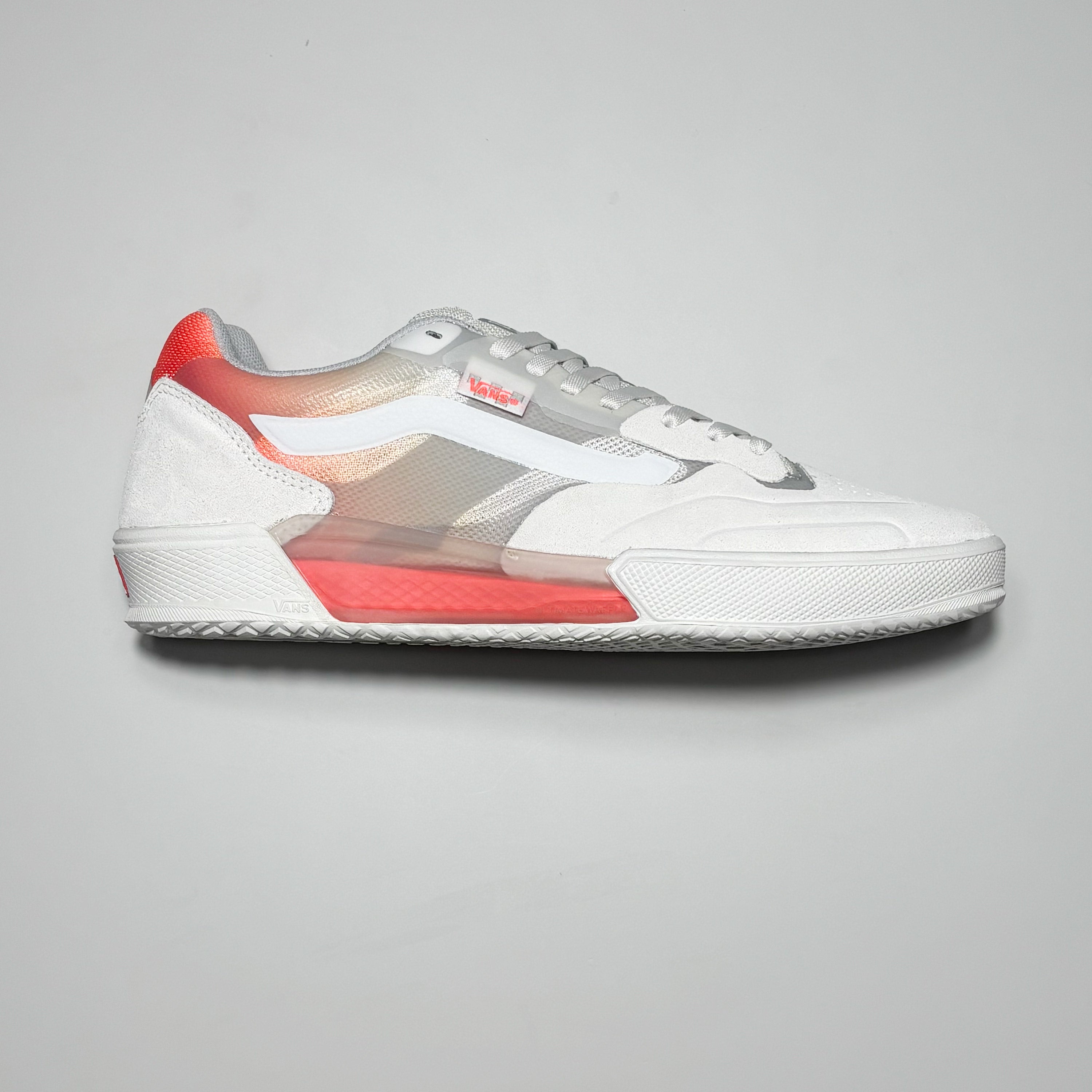 Side image of right shoe. White suede with red fading around heel collar.