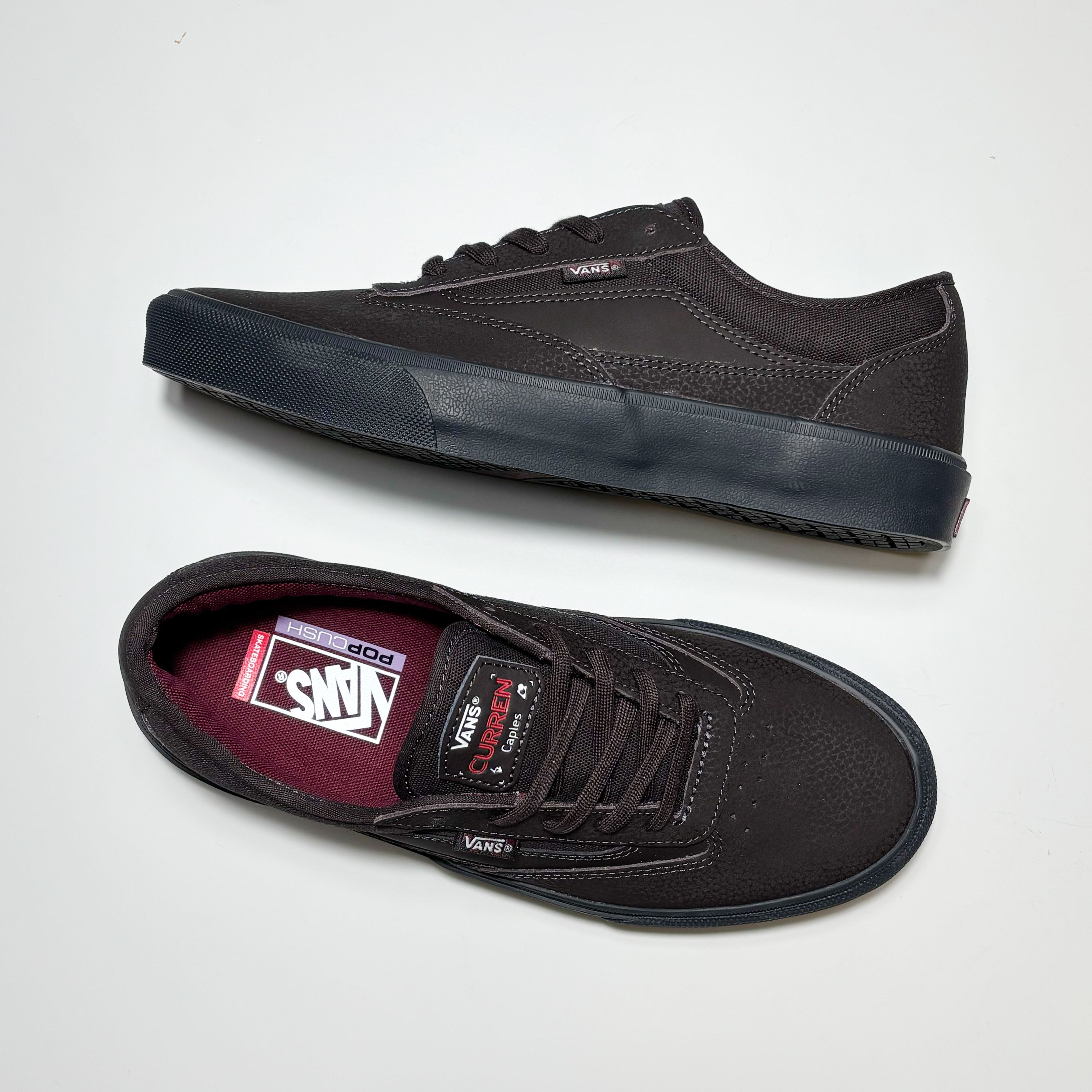 Toe down view with side profile.
Vans, Curren branding on tongue.