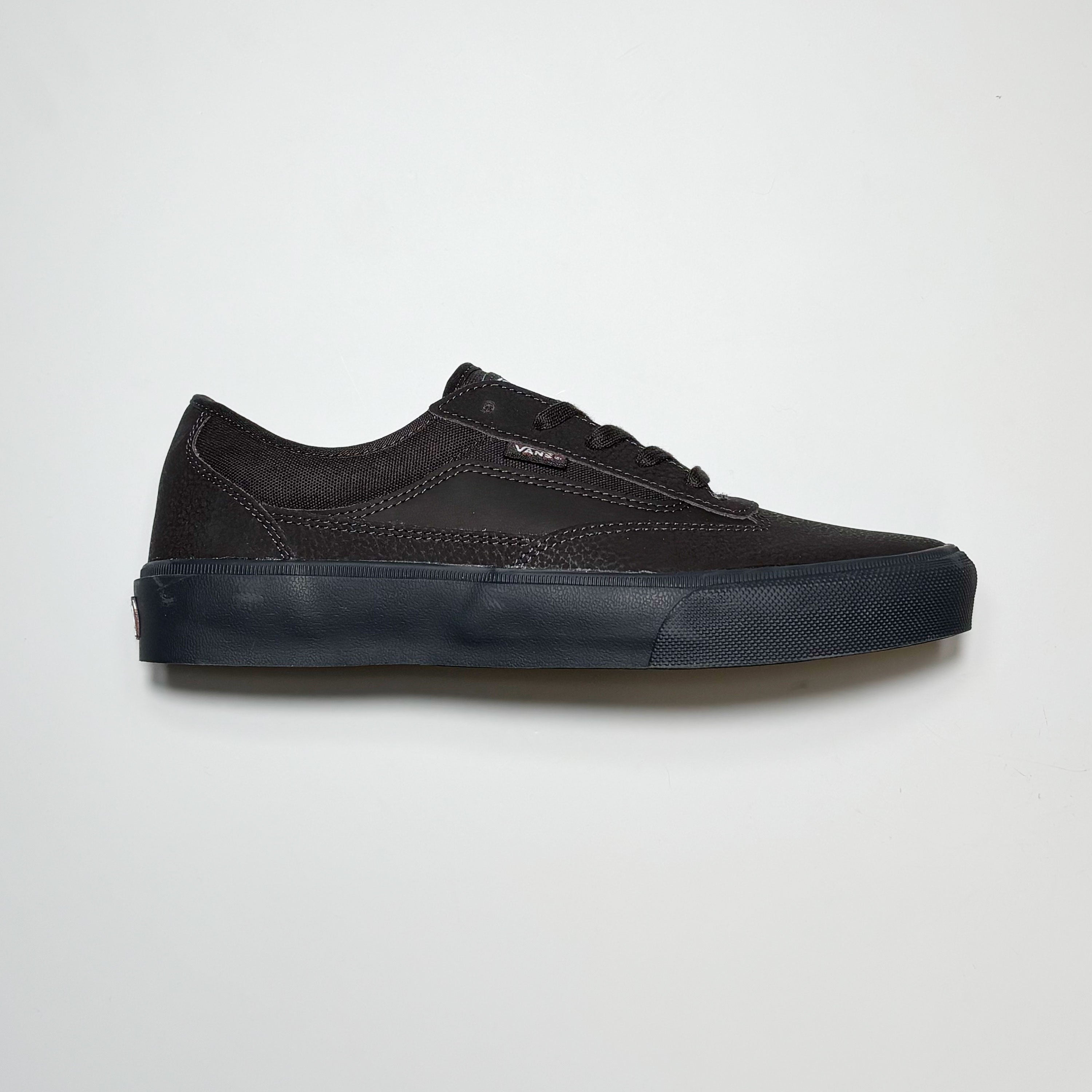 Side image of right shoe.
Dark brown leather with black midsole