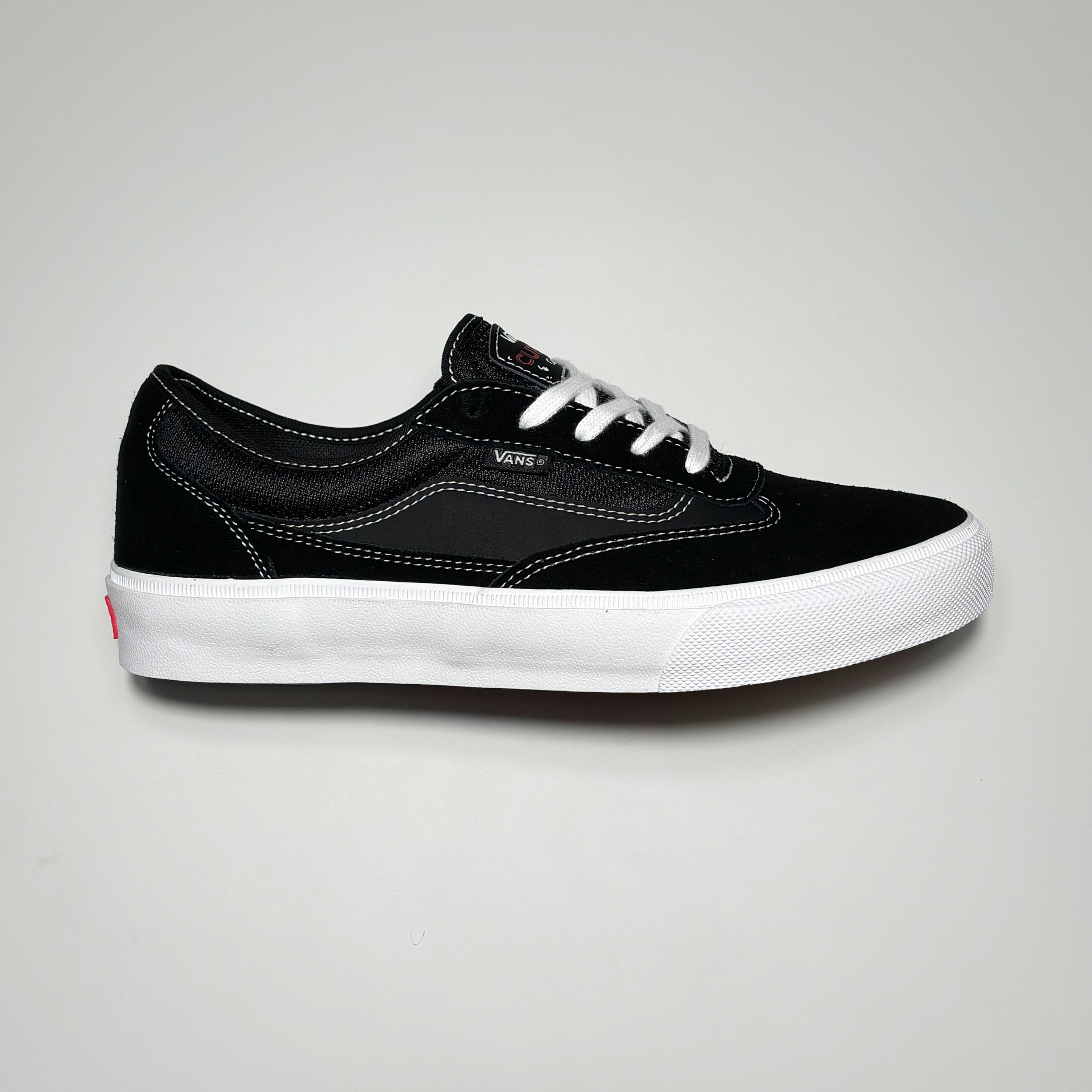 Side image of right shoe.
Black suede with white contrast stitch lines and outsole.