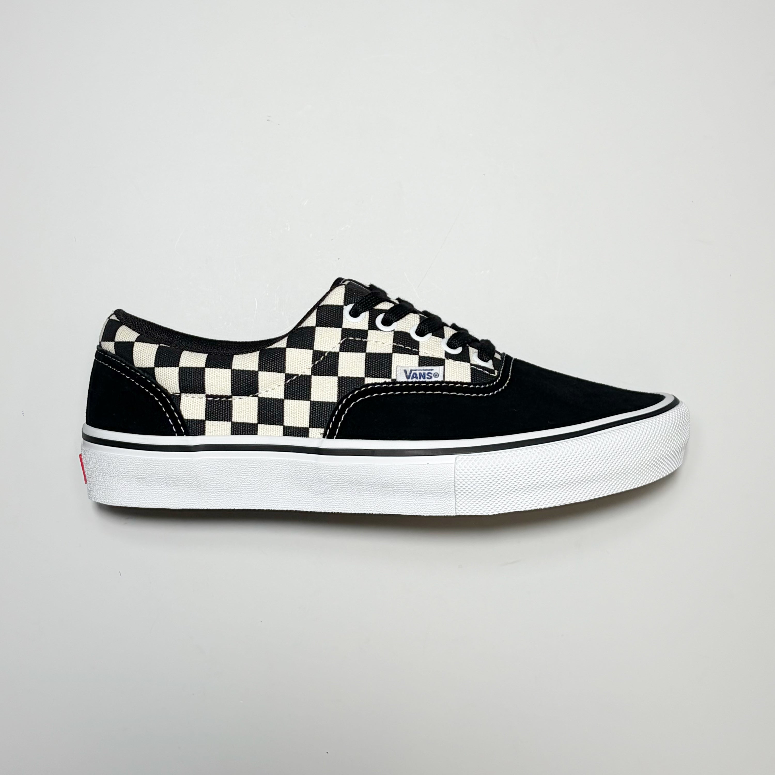 Right side image, Vans Skate Era Checkerboard sneaker. Black suede toe and heel panel with white outsole