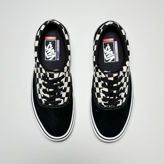 A pair of Vans Skate Era sneakers in black suede and canvas with a black and white checkerboard pattern on the laces and collar.