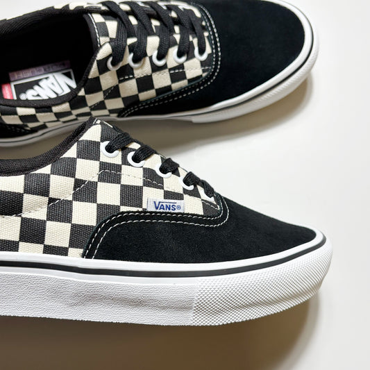 Black and cream checkerboard canvas sneakers with black suede overlays, black laces, and white rubber soles, shown on a clean white background.