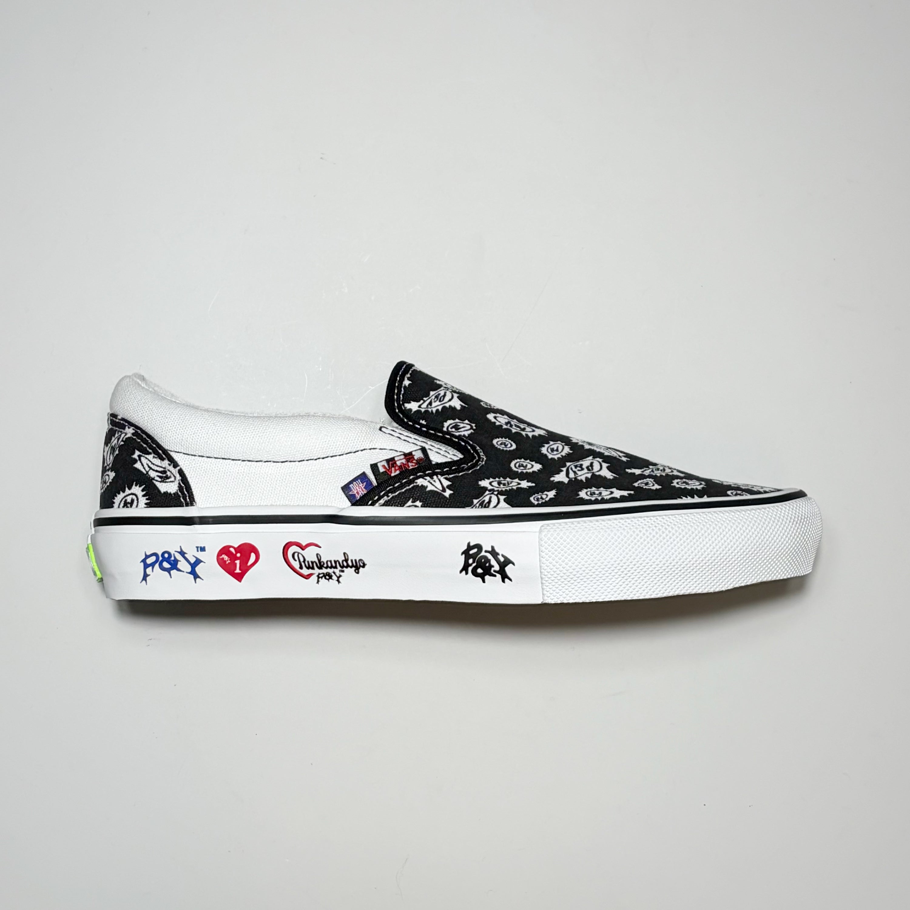 Right side image, Vans Skate Slip On with Punk and Yo branding on sidewall featuring all over print black canvas.