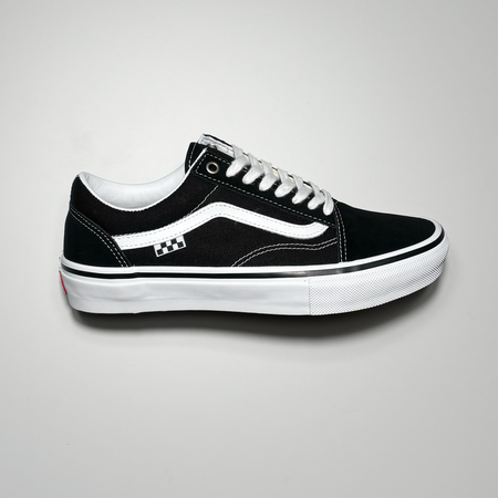 Side image of right shoe. Black suede toe with canvas mid panel and white stripe.