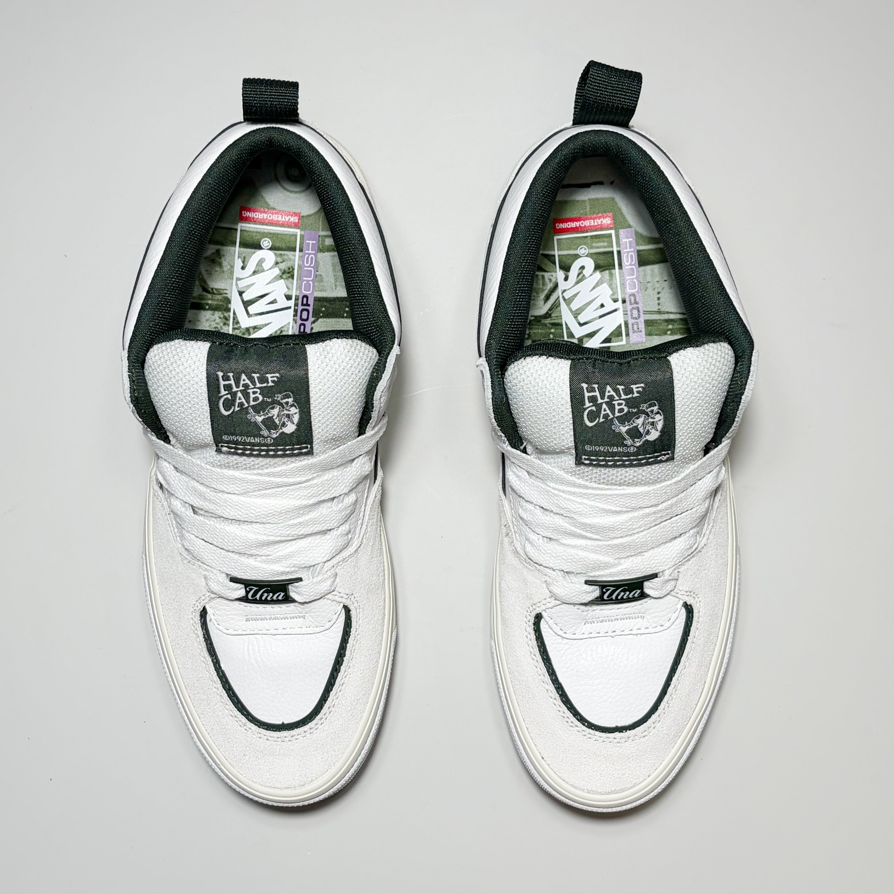 Toe down view of Vans Skate Half Cab Wafflecup Shoes by Una Farrar. White laces with green woven label on tongue.
