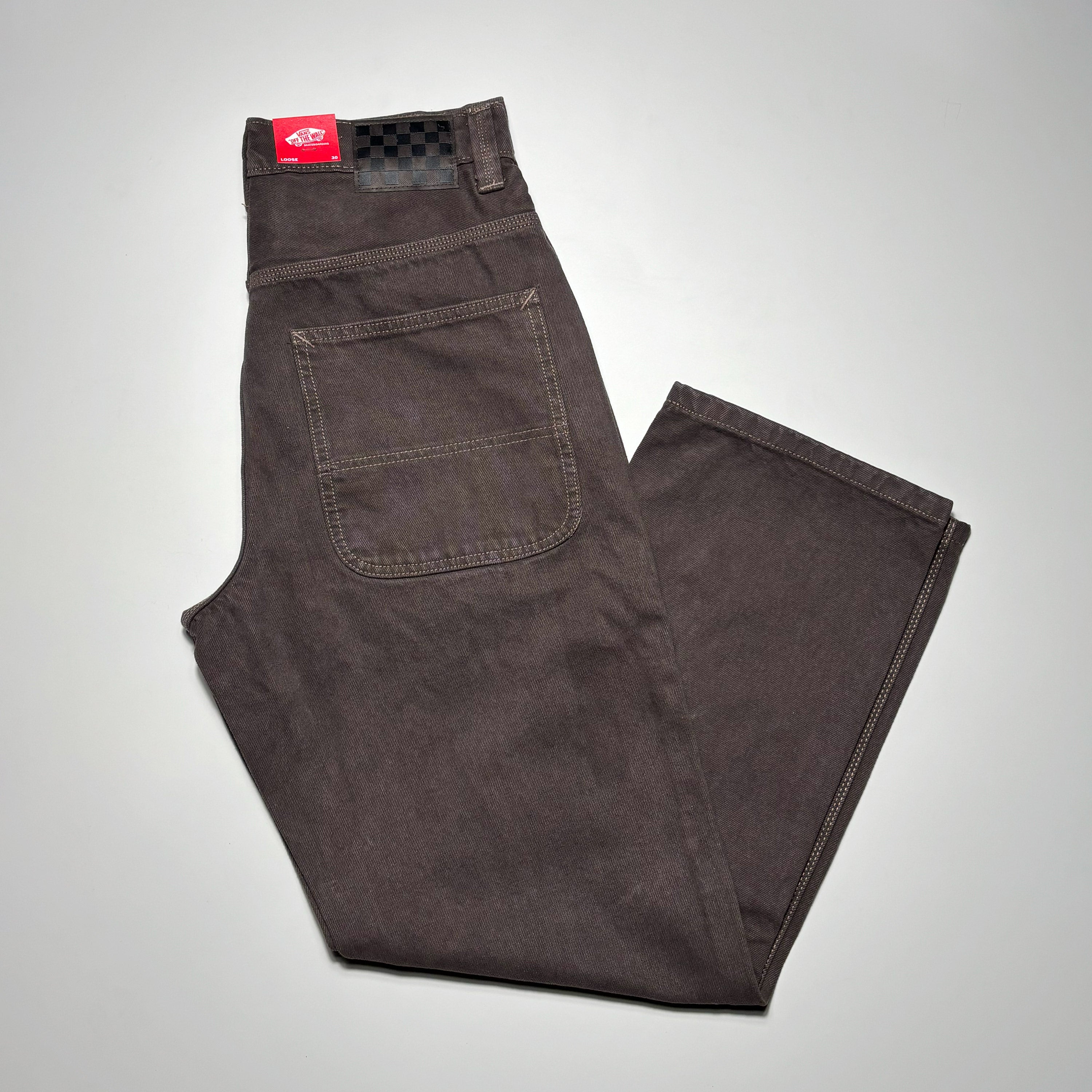 Folded image of denim with brown wash.