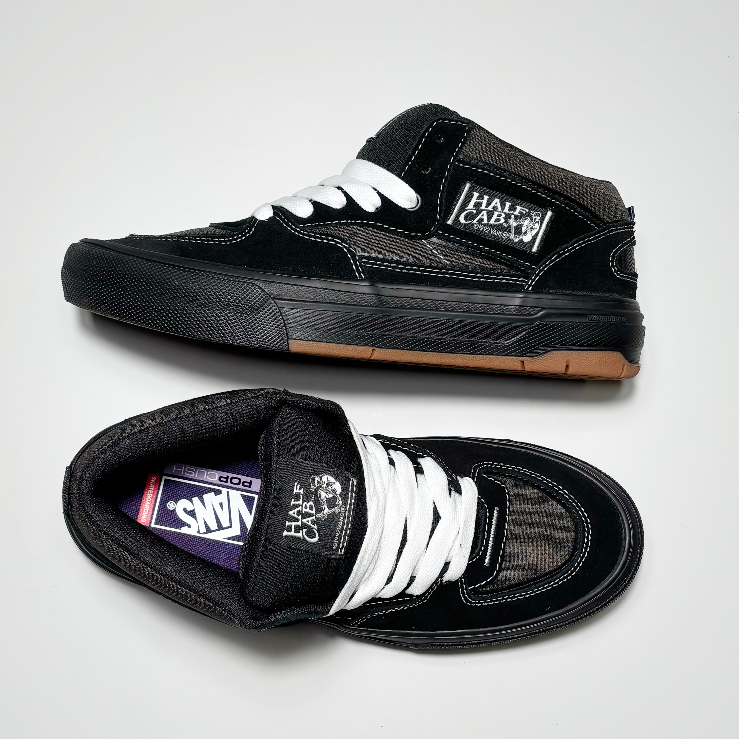 Toe down view with side profile. White contrast stitch and half cab label on tongue.