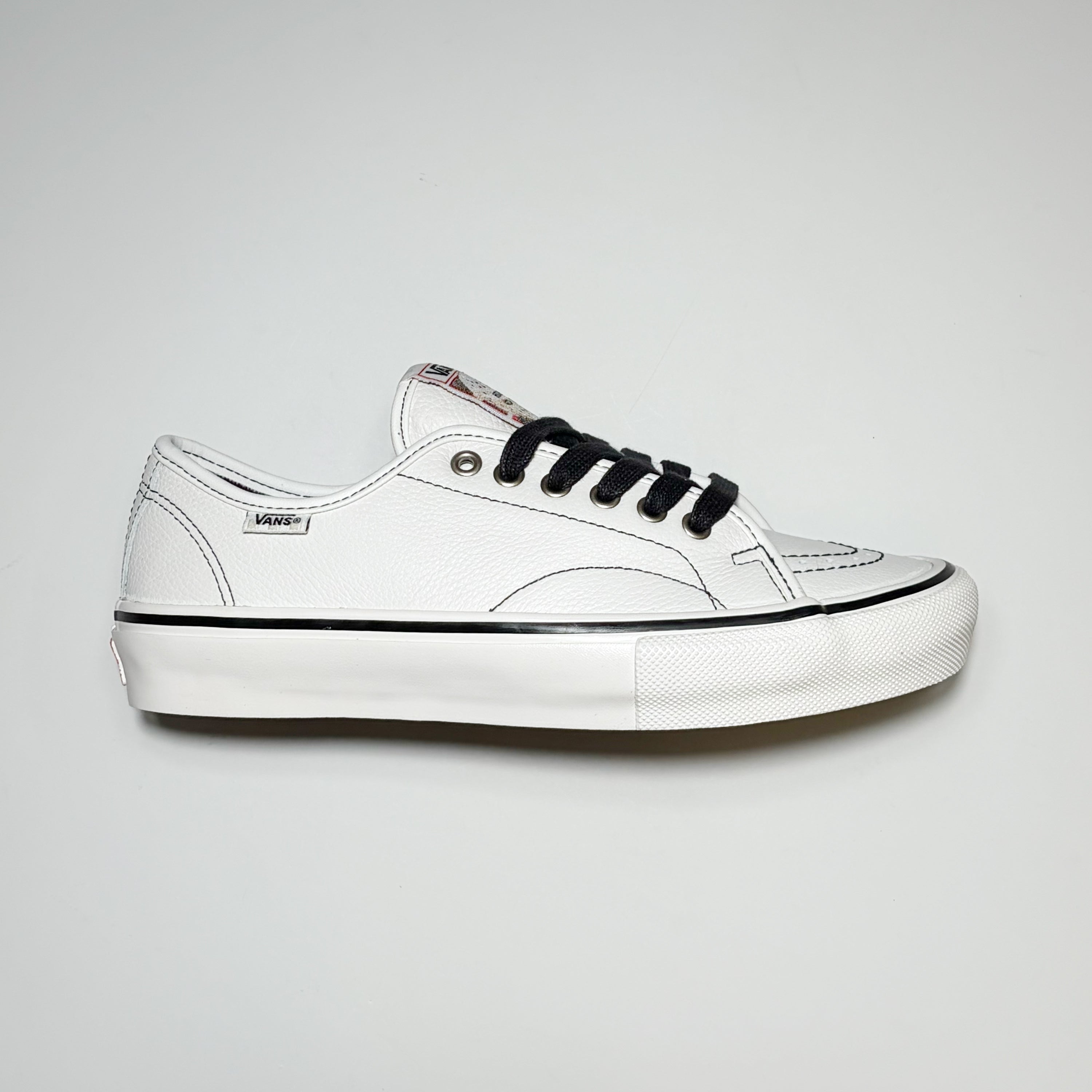 Right side image of shoe. Vans VCU AVE Classic in white leather with black contrast stitch and laces. Vans woven label on heel. VCU Limited Project Footwear