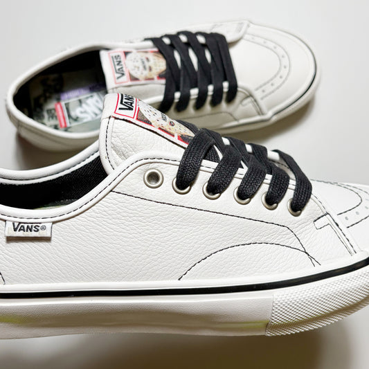 Close detail of Vans VCU AVE Classic shoe. Premium white leather with black contrast stitch and laces.
