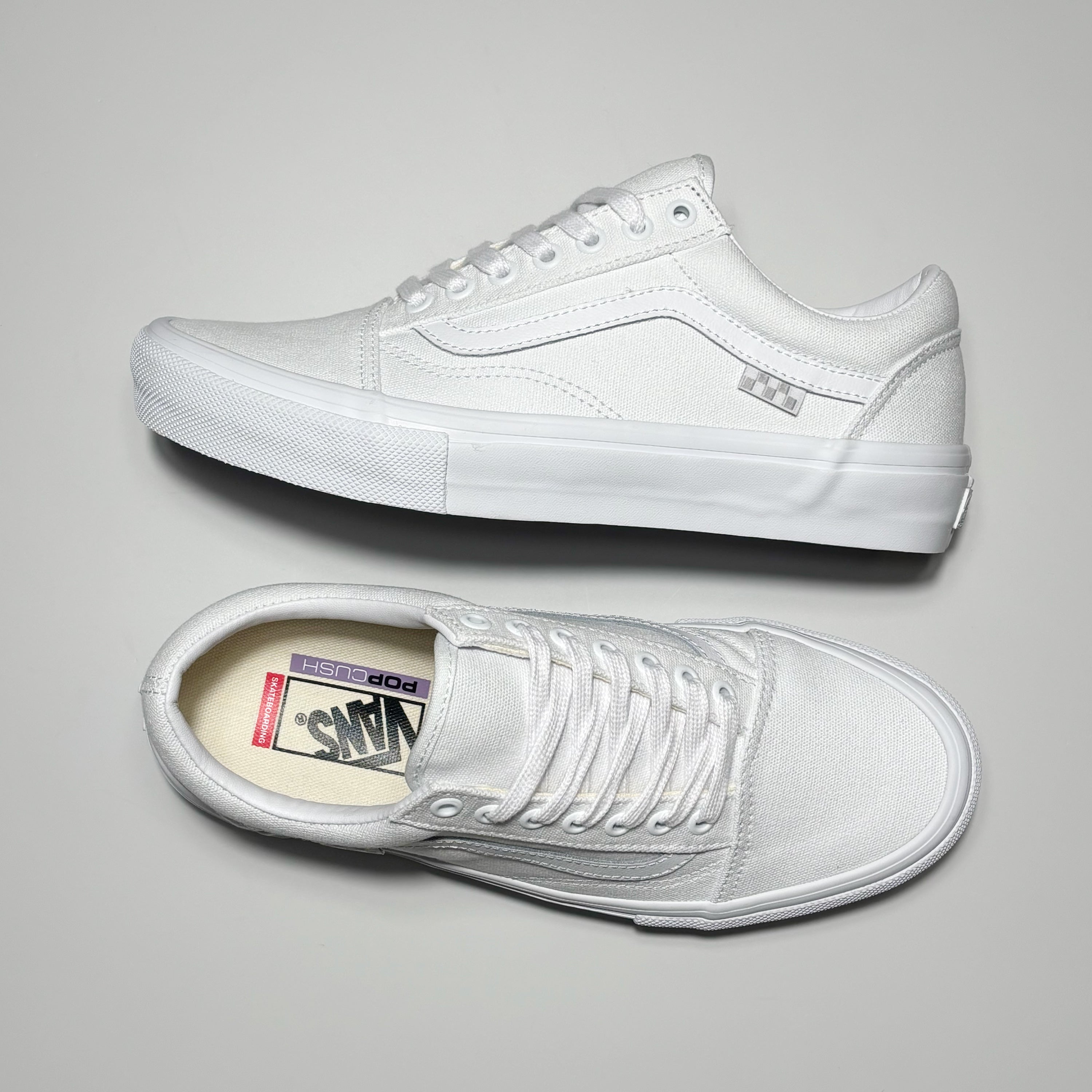 Toe down view with side profile. White/white canvas and outsole.