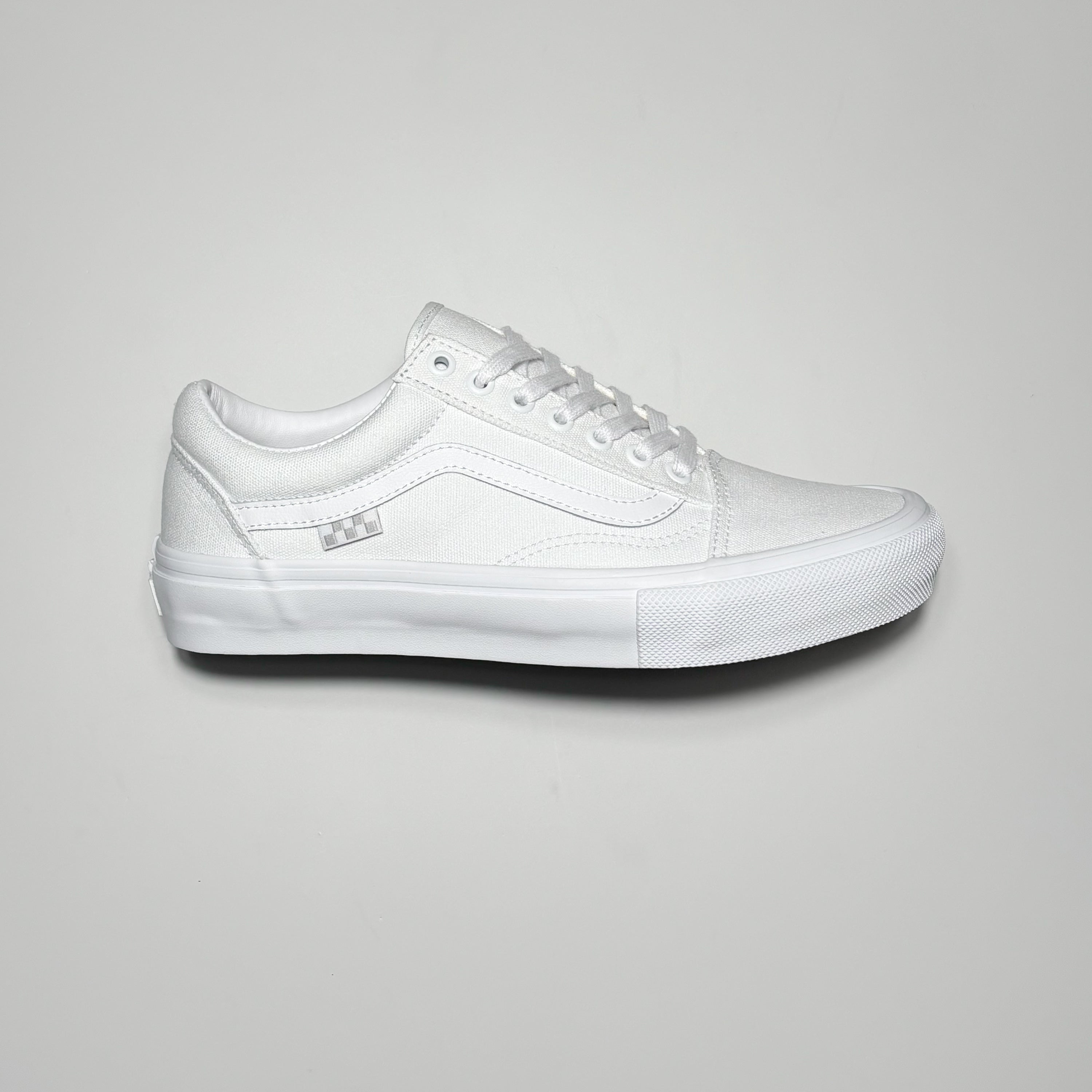 Side image of right shoe, white canvas with white stripe.