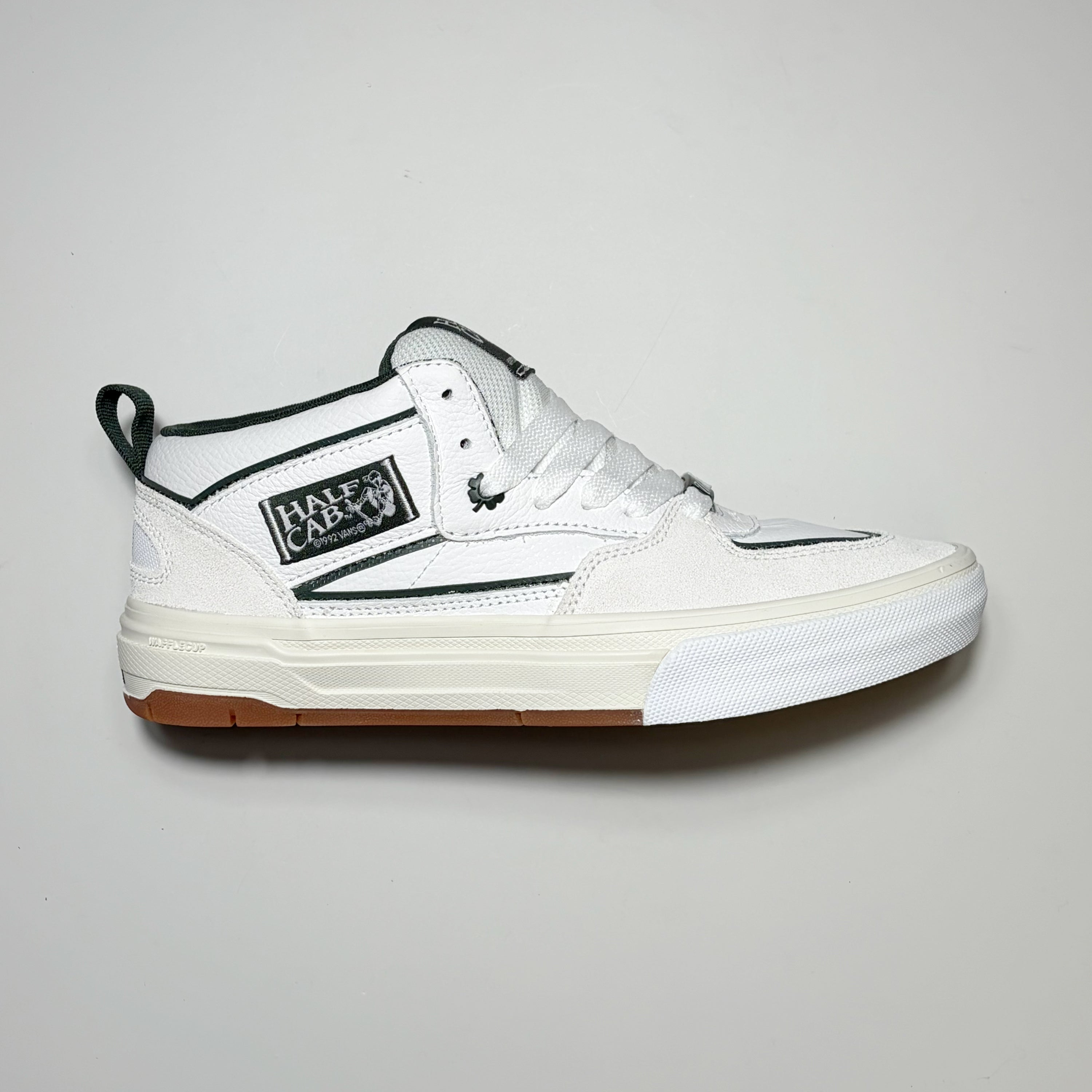 Right side image, Vans Skate Half Cab Wafflecup by Una Farrar. White suede with white leather panels and green trim. Green shamrock eyestay. 