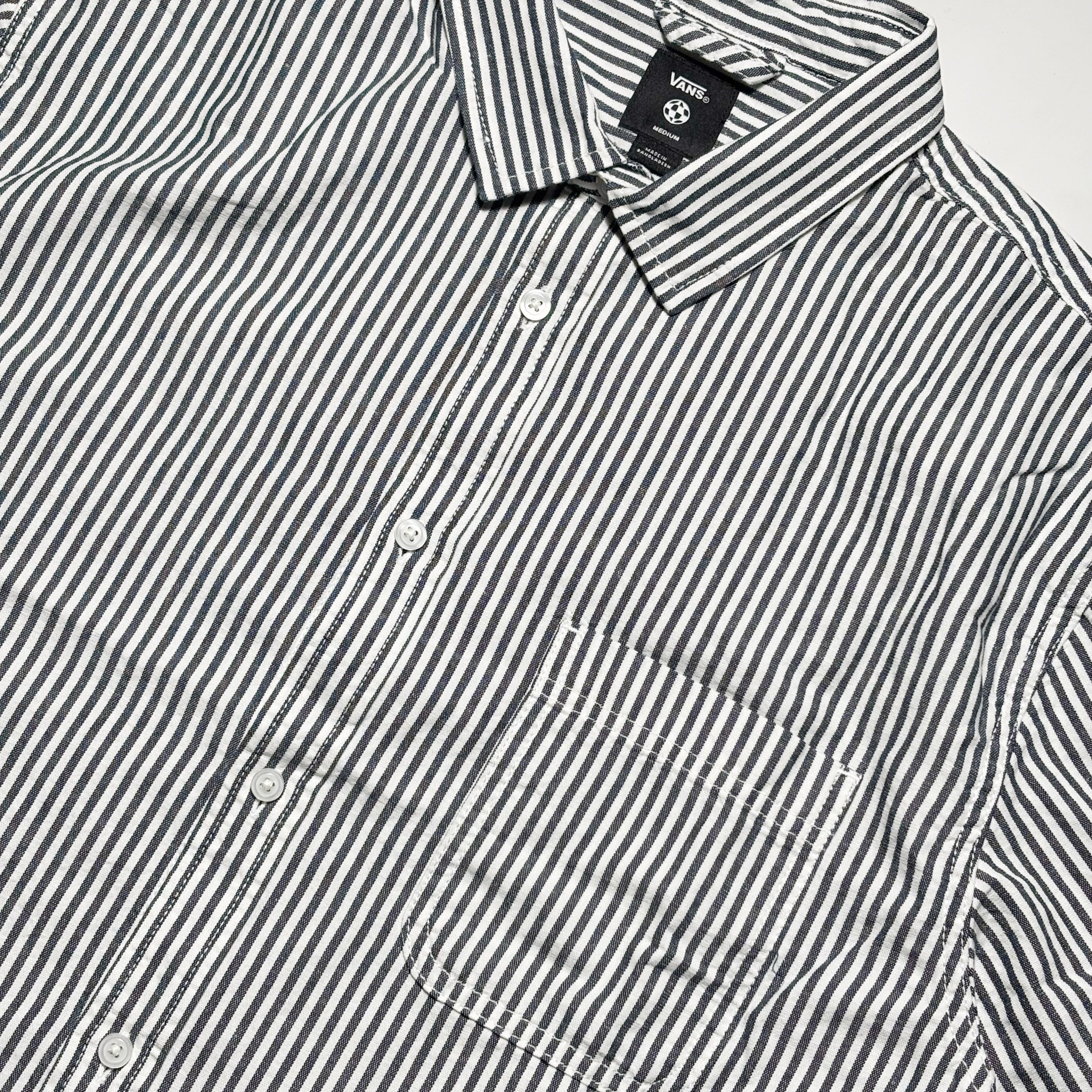 Close detail of black/white striped button up.