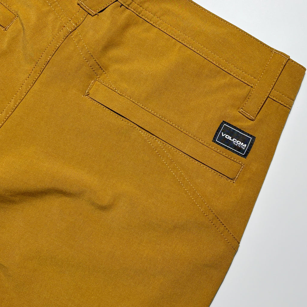 Back detail with woven label above pocket.