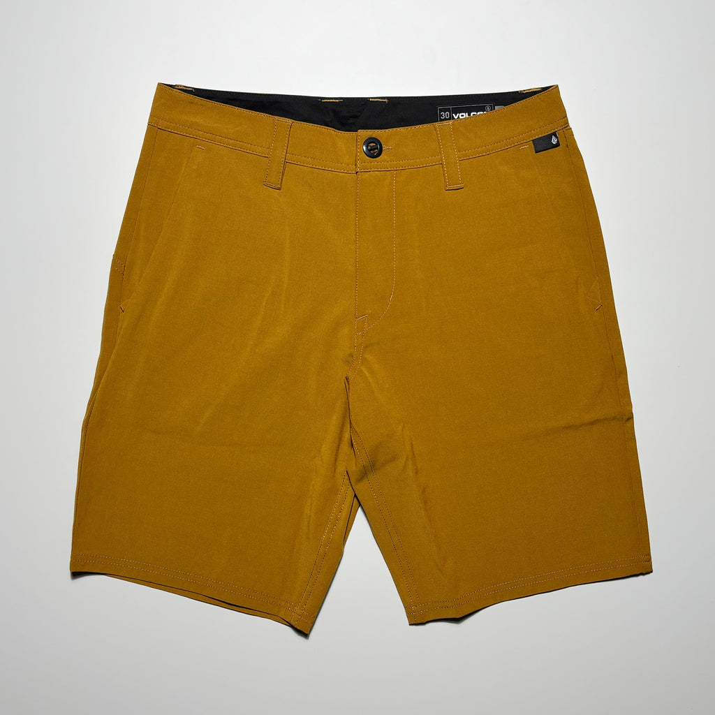 Front image of gold shorts with label on waist.