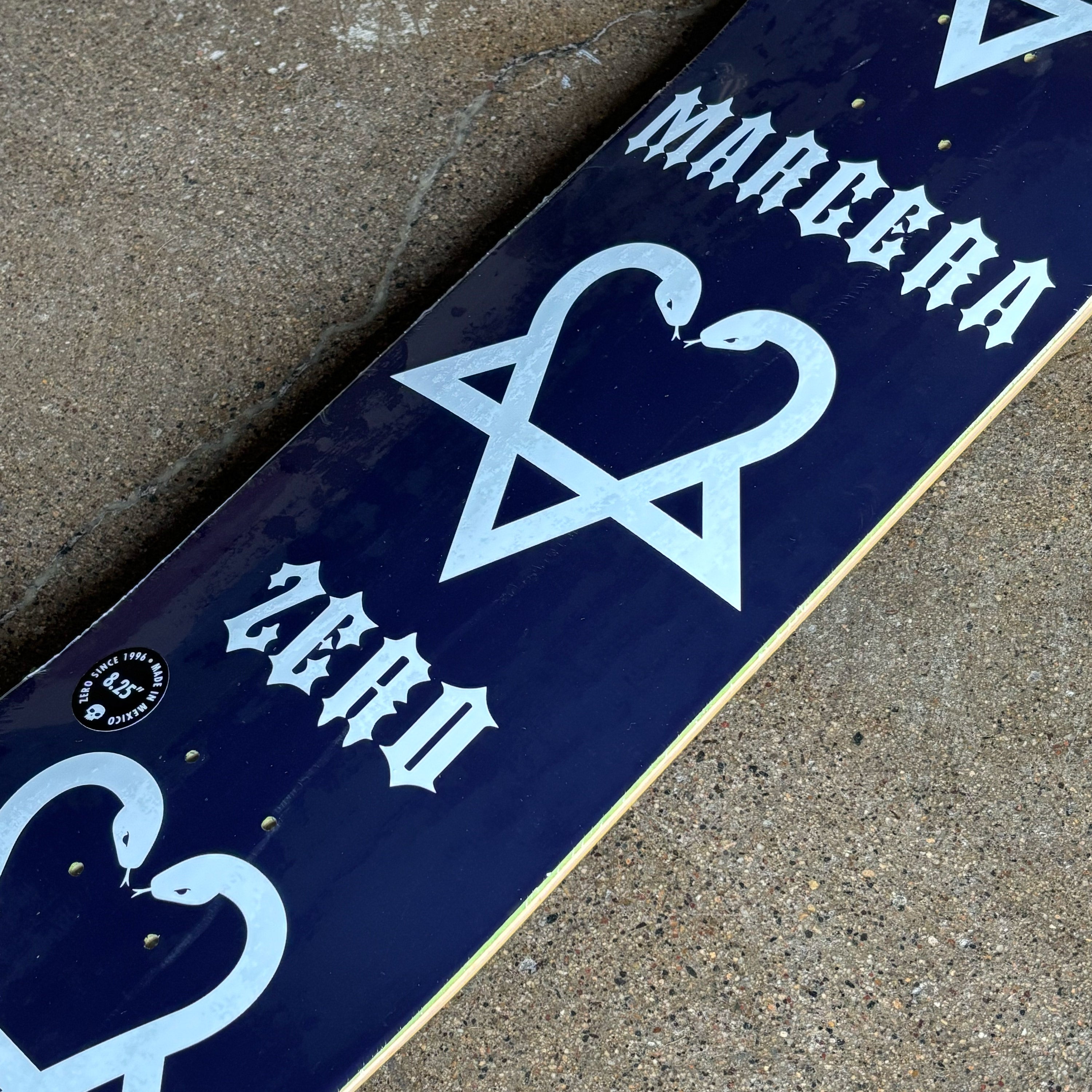 Close detail of snakes making a heart with Margera and Zero branding.