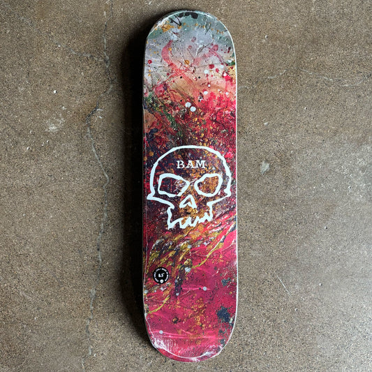 Full image of deck with colorful design and skull logo.