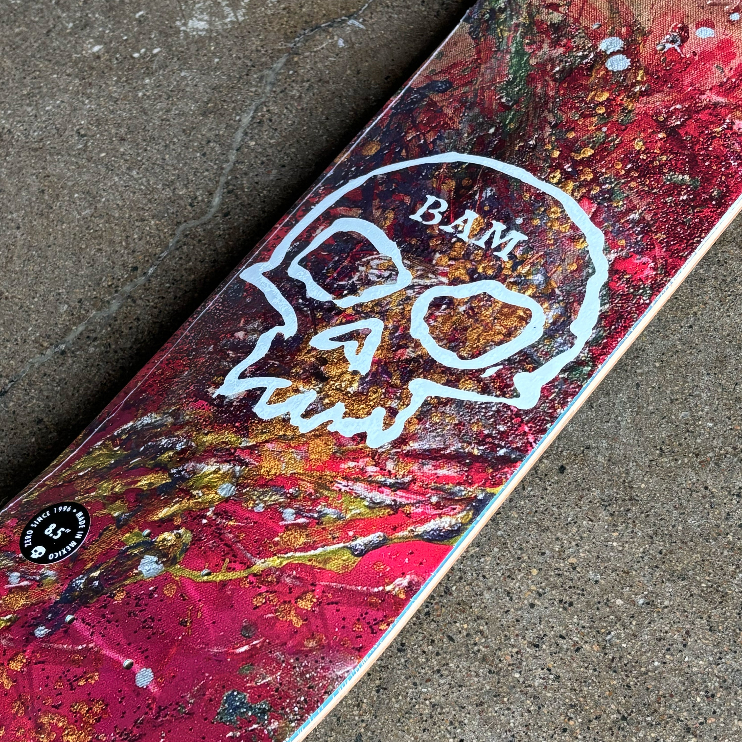 Close detail of single skull art on splattered background.