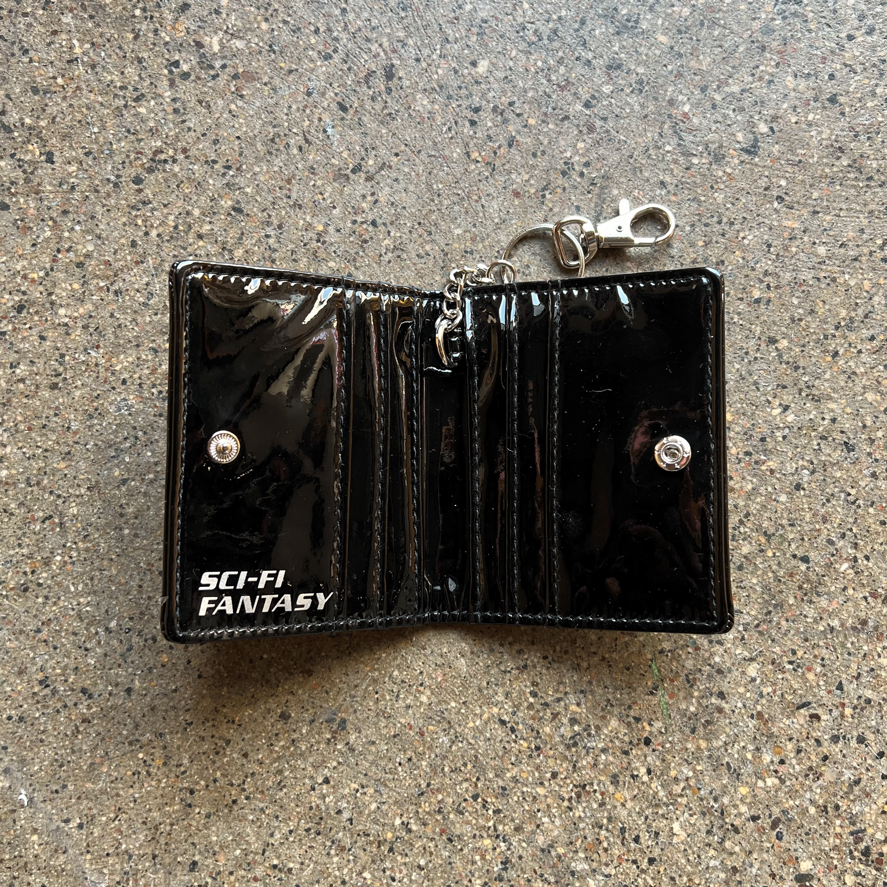 INSIDE LOOK BLACK PATENT LEATHER WITH SNAP CLOSURE AND KEYCHAIN CLASP WITH WHITE PRINTED SCI-FI FANTASY LOGO