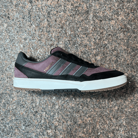 SIDE VIEW OF THE ADIDAS TYSHAWN 2 PRO MODEL SHOE IN FIG, BLACK AND GREY WITH WHITE SOLE AND GUM TRIM DISPLAYED ON GRANITE